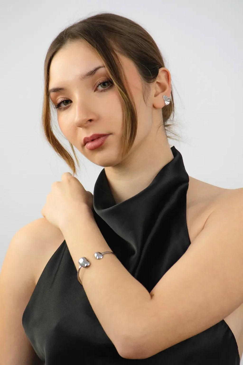Woman wearing a black top with a plain background