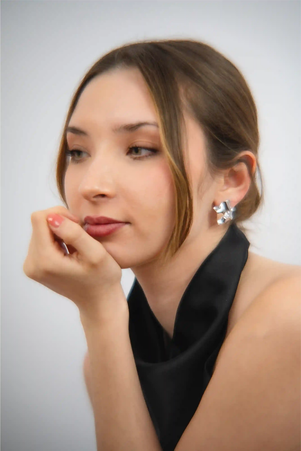 Woman wearing a black scarf with a neutral background