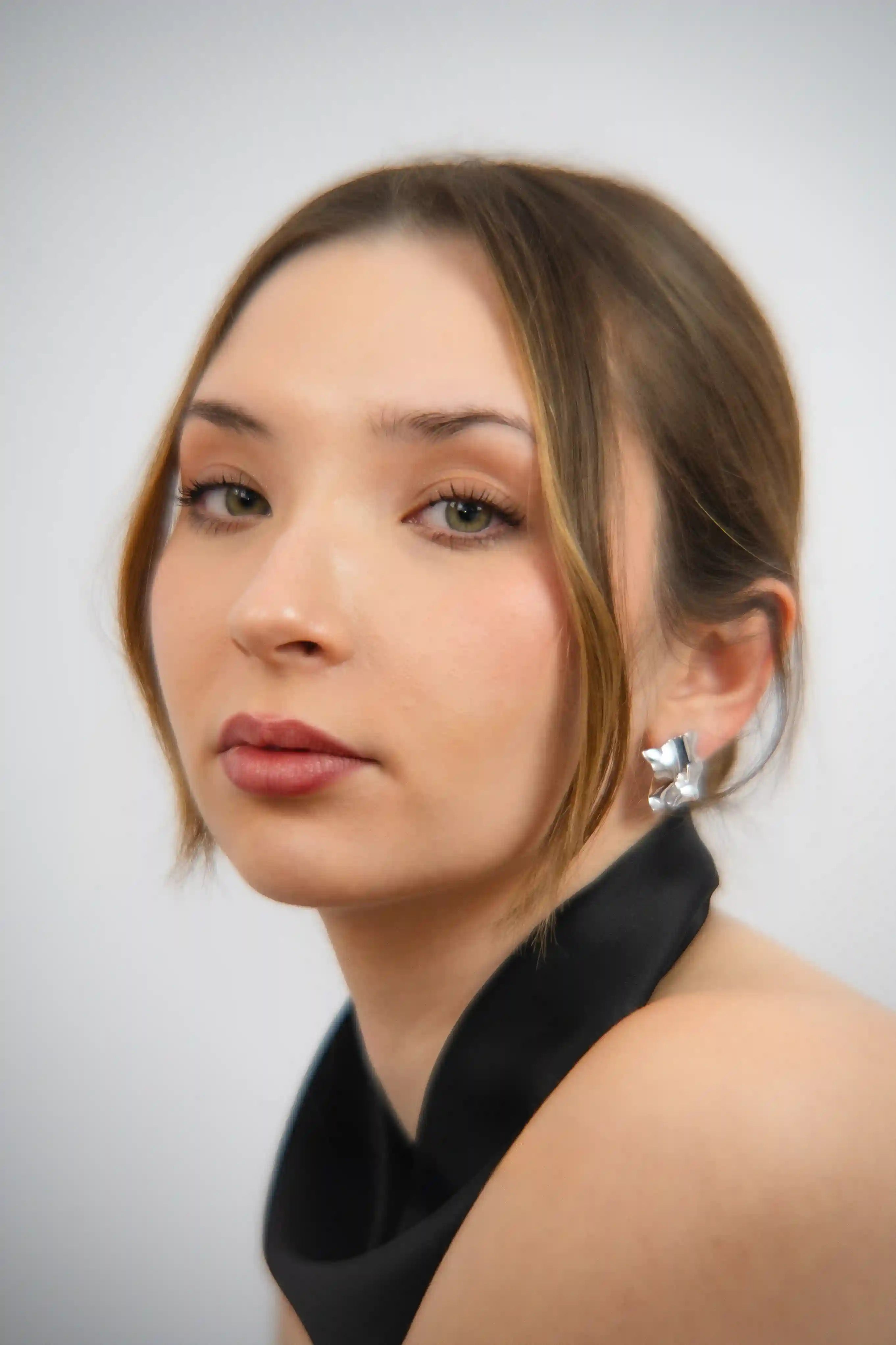 Woman wearing a black top with a white background