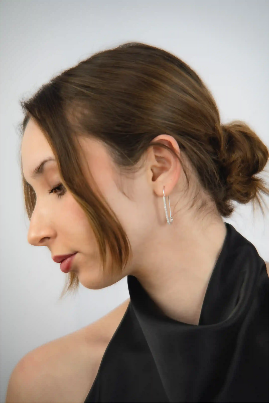 Woman wearing a black top with a plain background