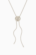 Silver necklace with a circular pendant on a white background