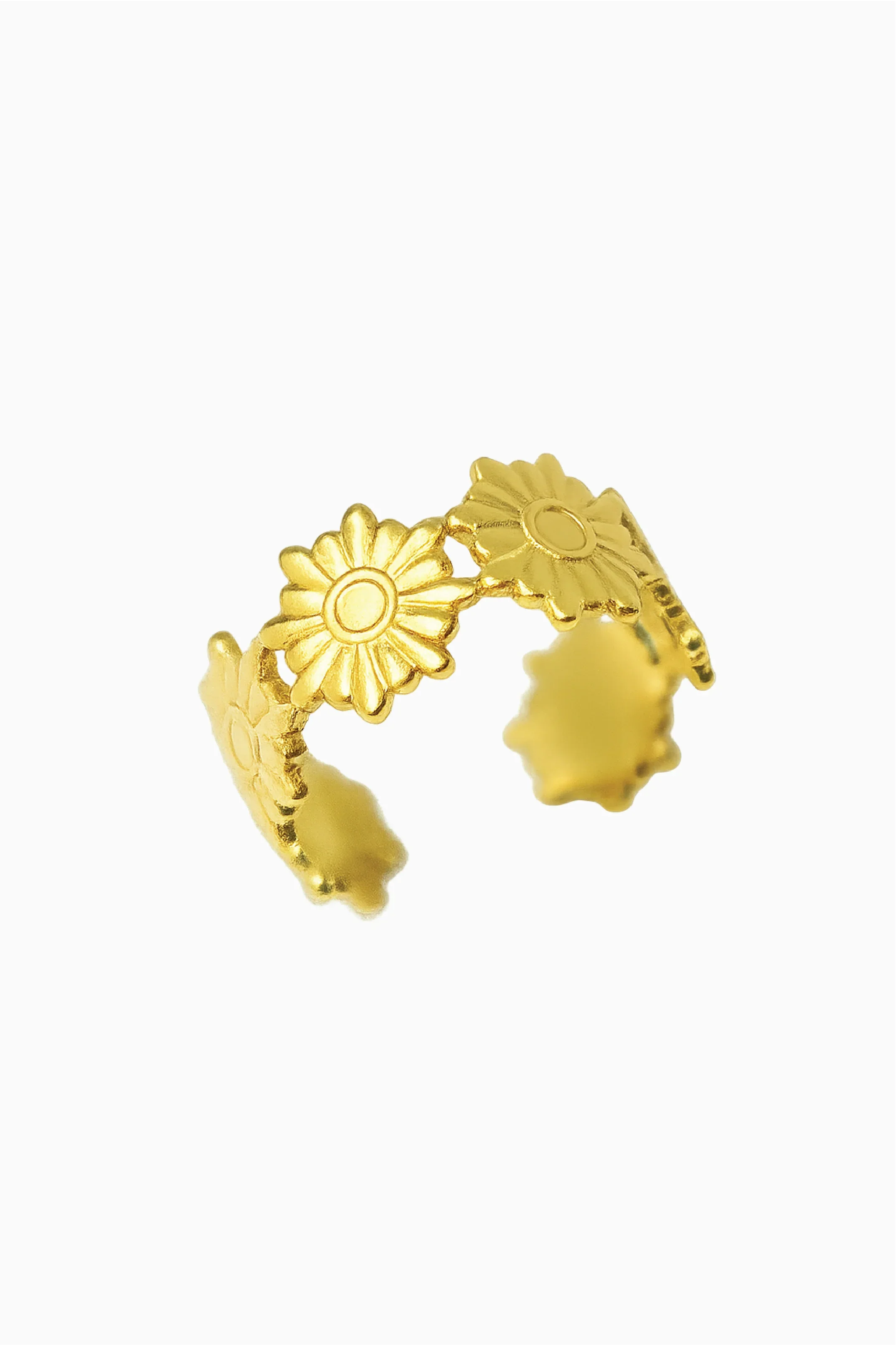 Gold ring with floral designs on a white background